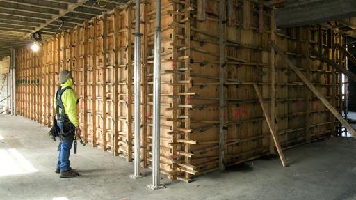 Worker inspects wall framing