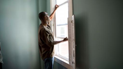 Man inspects window